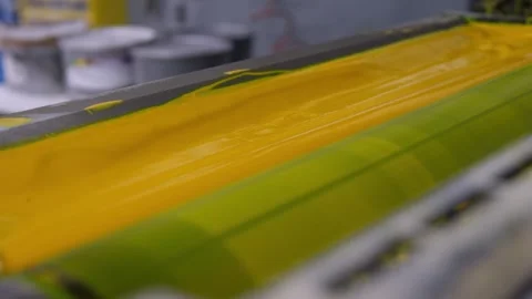Yellow ink unit inside an offset printing press Stock Footage 334776381