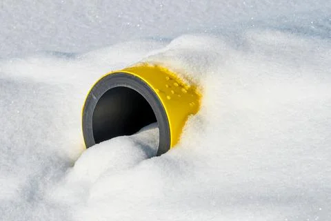 Yellow Jacketed Pipe under the snow. Stock Photos