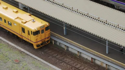 A yellow JR train departing platform, Hakodate, Japan, 2026.09.10. Stock Footage 345431995