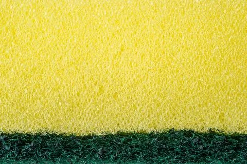 Yellow kitchen sponge macro texture with porous cleaning surface pattern 库存照片