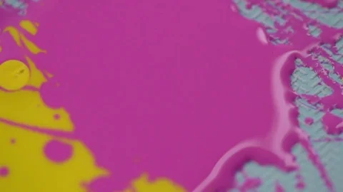 The yellow lacquer drips onto the pink nail polish. Stock Footage 77550686