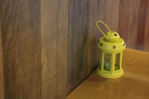 Yellow lantern on the table Stock Photos