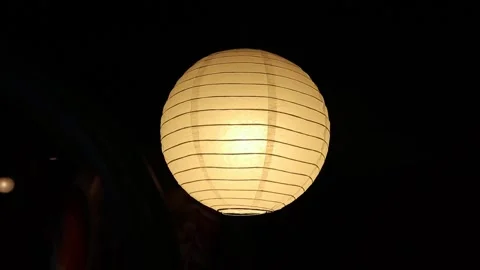 Yellow lanterns on a dark background Stock Footage 246430639