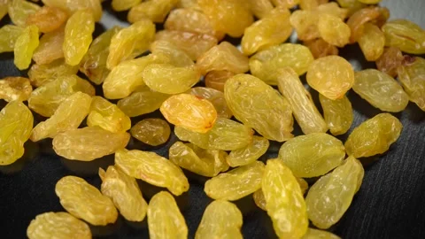 Yellow large raisins on a dark background Stock Footage 146513868