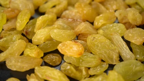 Yellow large raisins on a dark background Stock Footage 146584046