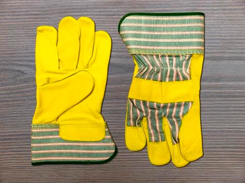 Yellow leather work gloves Stock Photos