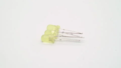Yellow LED electronic component rotates on white background isolated. 스톡 동영상 235391843