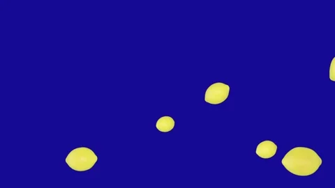 Yellow Lemon falling down from the top on blue screen background Video stock 322790694