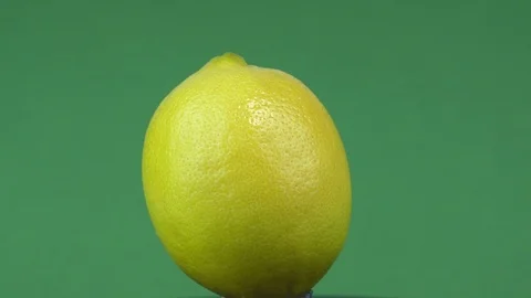 Yellow lemon fruit on a green background.1 Stock Footage 123425976