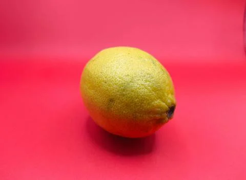 Yellow lemon on a red background Stock Photos