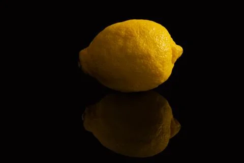 Yellow lemon with reflection on black Stock Photos