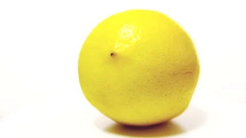 Yellow Lemon with shadow on a white table, rotation 360 degrees. White backgroun Stock Footage 149274169