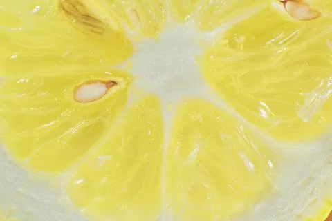 Yellow lemon slice with bone close-up (macro) Stock Photos