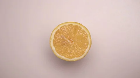 Yellow lemon on a white table, rotation 360 degrees. White background Stock Footage 127573440