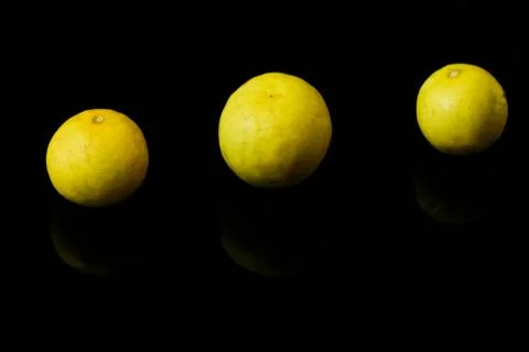 Yellow lemons on black isolated background Stock Photos