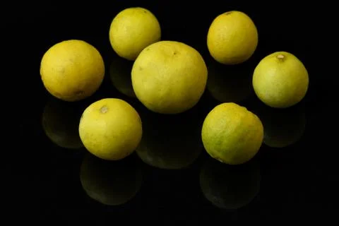 Yellow lemons on black isolated background Stock Photos