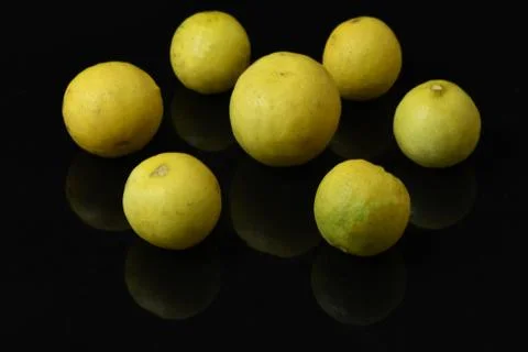 Yellow lemons on black isolated background Stock Photos