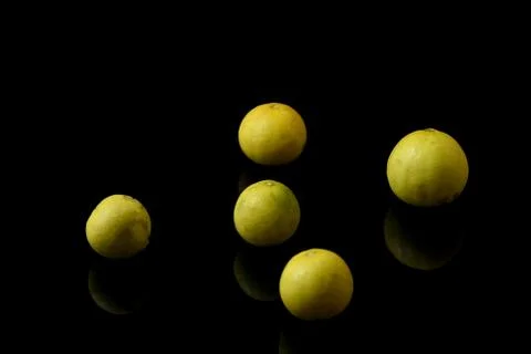 Yellow lemons on black isolated background Stock Photos