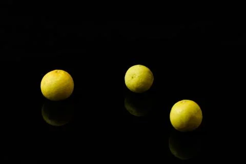 Yellow lemons on black isolated background Stock Photos