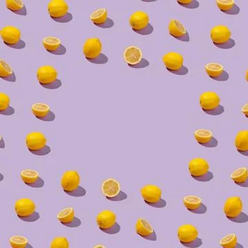 Yellow lemons border frame on abstract lavender background Stock Photos