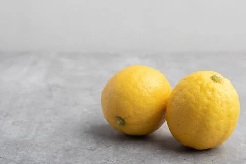 Yellow lemons on a gray background Stock Photos
