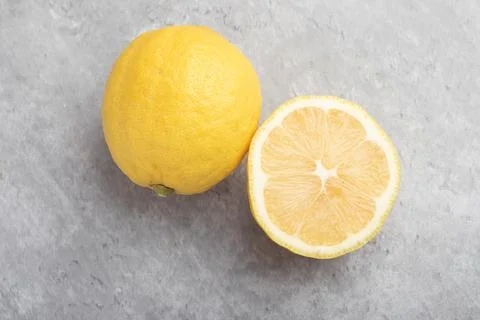 Yellow lemons on a gray background Stock Photos