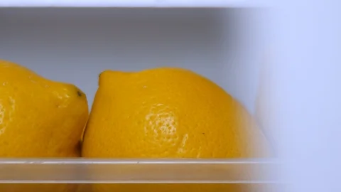 Yellow lemons keeping freshness in fridge. Citrus fruits for food preparing Stock-Footage 102872653