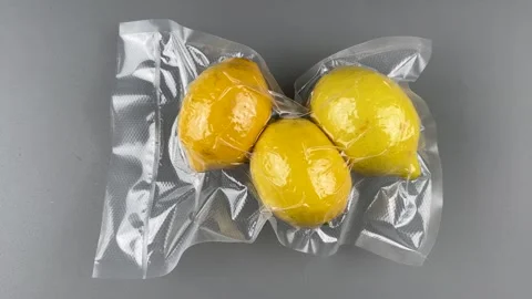 Yellow lemons in vacuum-sealed package Stock Footage 265034221