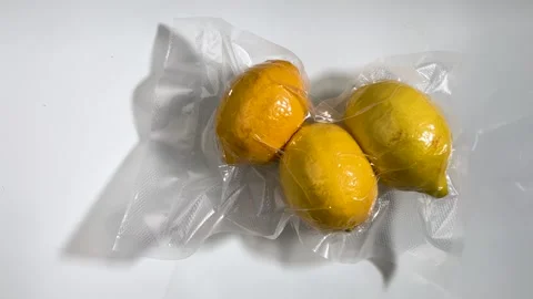 Yellow lemons in vacuum-sealed package f Video stock 265035266