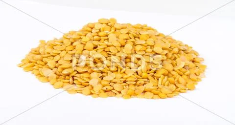 Yellow lentils isolated on white background.Macro shot Stock Photos