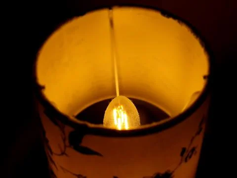 Yellow light from the bedside lamp Stock Photos
