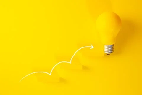 Yellow light bulb with arrow going up on yellow background. Business concept Stock Photos