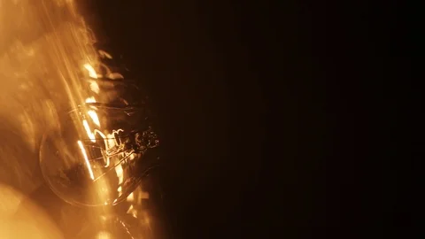 Yellow light lamp on black background glass energy generation bright glow Stock Footage 98215623