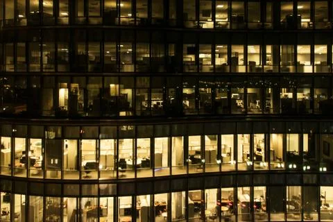 Yellow light windows of an office building at night in Boston late night at w Stock Photos