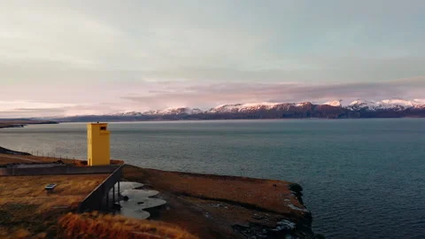 Yellow lighthouse, Geosea spa with the ocean and snowy mountains Stock Footage 261129848