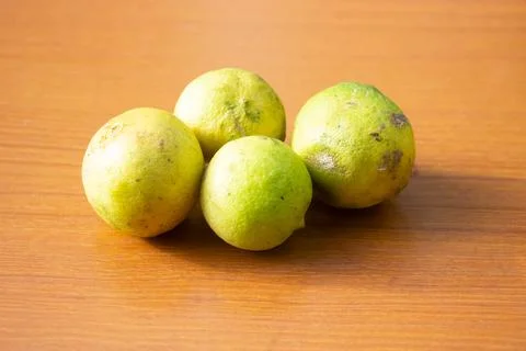 The yellow lime placed on the table is brown Stock Photos
