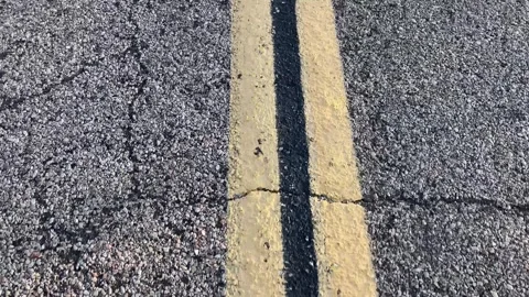 Yellow line continues a road marking on the pavement of an endless highway. Stock Footage 254004679