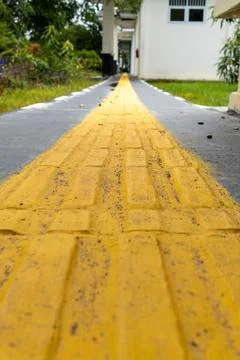 The yellow line indicates the way for the visually impaired Stock Photos