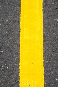Yellow line on the road texture background Stock Photos
