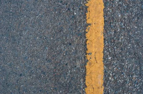 Yellow line on the road texture background Stock Photos