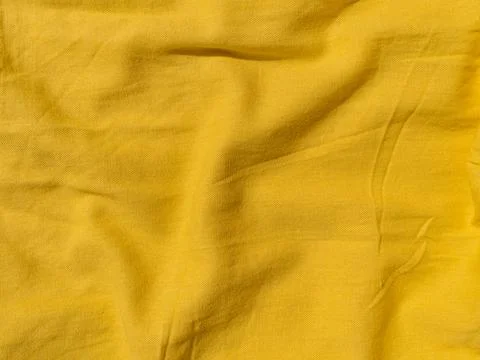 Yellow linen cloth texture pattern summer abstract design. Wavy natural texti Stock Photos