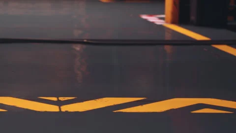 Yellow Lines Create a Pattern on a Freshly Painted Industrial Floor Stock Footage 348410083