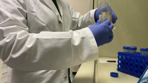 Yellow liquid being poured into test tube Stock Footage 315761500