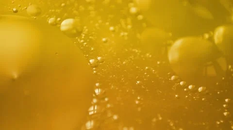 Yellow liquid with bubbles Stock Footage 20653749