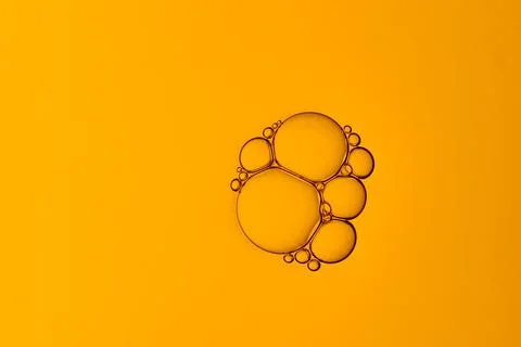 A yellow liquid with bubbles in it Stock Photos