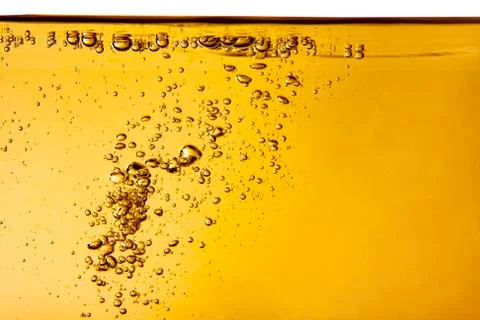 Yellow liquid with bubbles Stock Photos