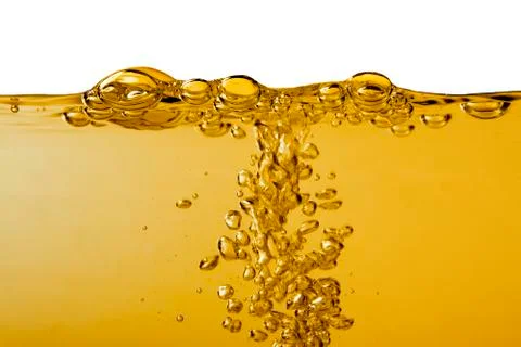 Yellow liquid with bubbles on white Stock Photos