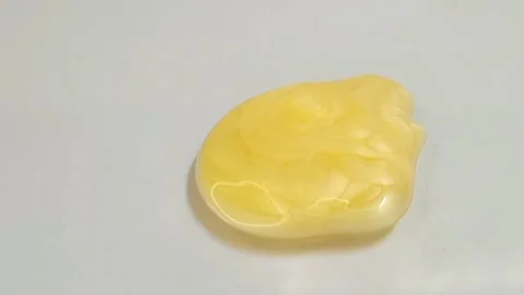 Yellow liquid creamy texture face wash, shampoo, cleanser, cosmetic or skincare Stock Footage 297657182