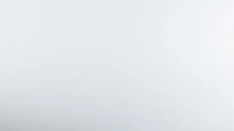 Yellow liquid descends from top of frame, pluming out into a cloud over white BG Stock Footage 63885731
