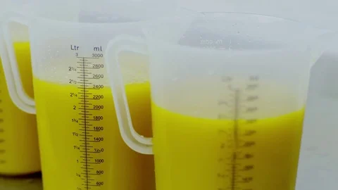 Yellow liquid in the measuring jug Stock Footage 72282924